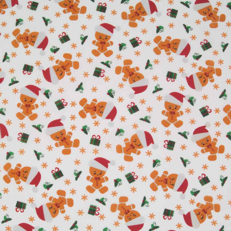 Gingerbread men, gifts and green holly printed on a white polycotton fabric