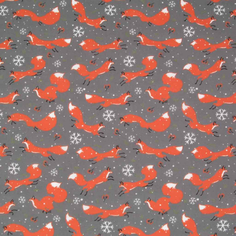 Jumping foxes, snowflakes and stars are printed on a grey polycotton fabric