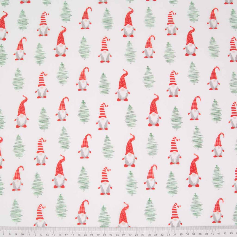 Cute on trend christmas gonks and trees are printed on a white polycotton fabric with a cm ruler at the bottom