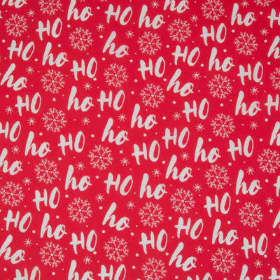 White festive Ho ho hos are printed on a red polycotton fabric.