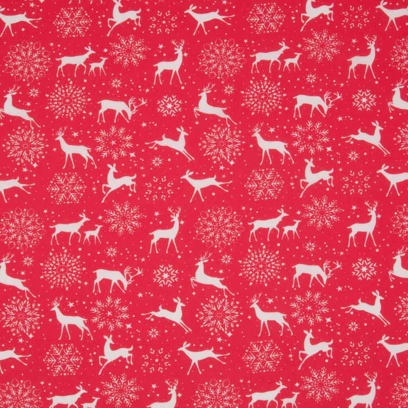 White reindeer and snowflakes are printed on a red, christmas polycotton fabric