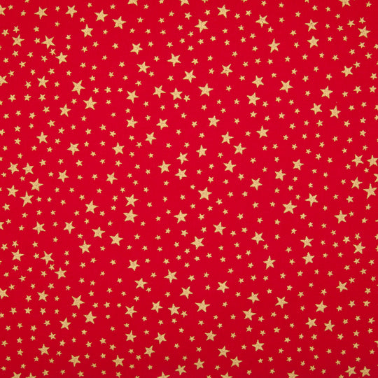 A red christmas cotton fabric featuring small metallic gold stars in a tossed pattern