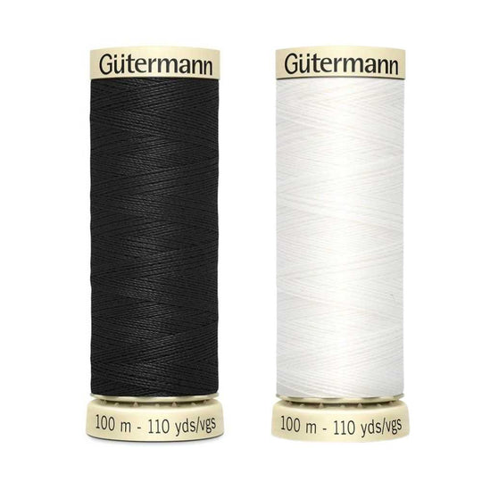 A reel of Gutermann sew-all thread in black or white