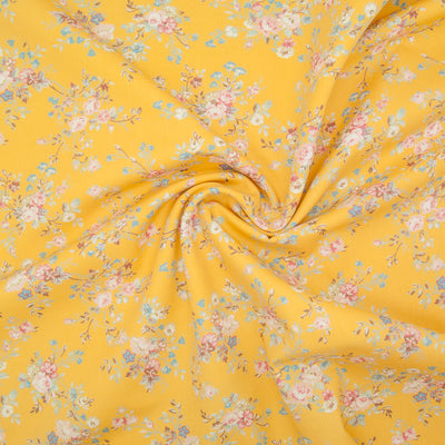 A beautiful, delicate floral print by Rose and Hubble printed on lemon yellow cotton poplin fabric with swirl for drape perspective