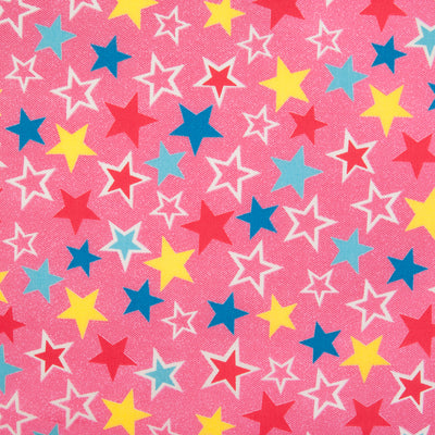 Red, Yellow and Blue Stars are printed on a cotton poplin fabric by Rose & Hubble with a Pink background