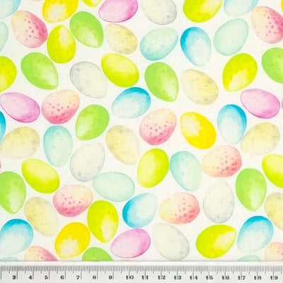 Colourful easter eggs in pinks, blue and green are printed on a quality white 100% cotton fabric. with a cm ruler