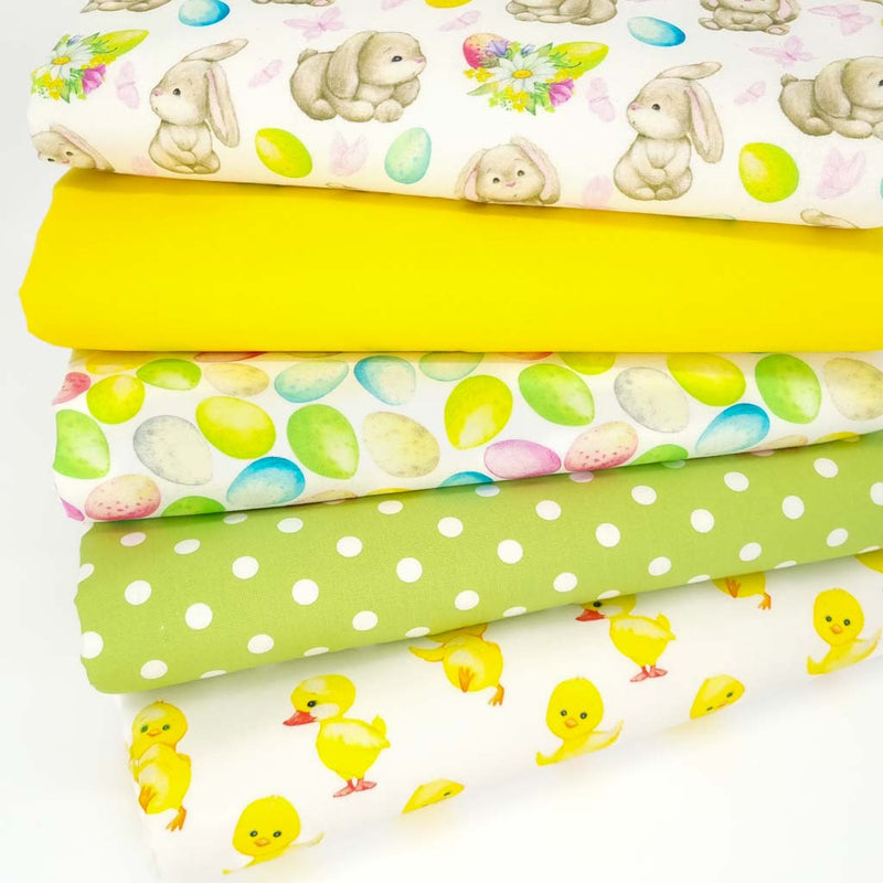 An easter fat quarter bundle of 5 cotton fabrics printed with bunnies, chicks and easter eggs