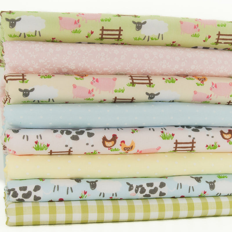 A fat quarter bundle of eight fabric prints including four farmyard designs, two spots a green gingham and a pink floral