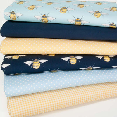 Six cotton fat quarters printed with bees, spot and checks on yellow and navy backgrounds 