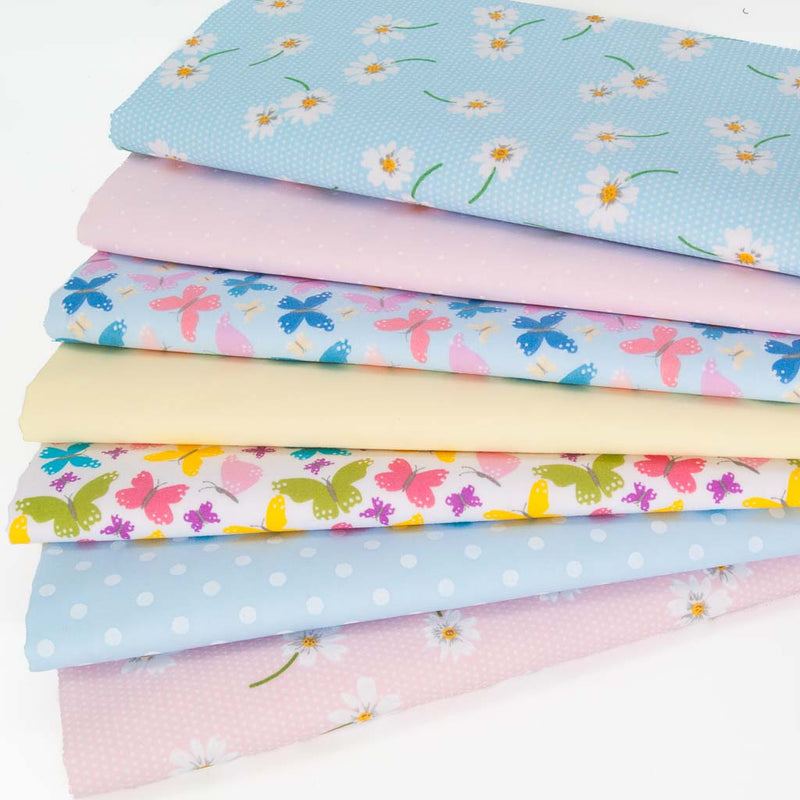 A fat quarter bundle of 7 polycotton designs with daisies and butterflies