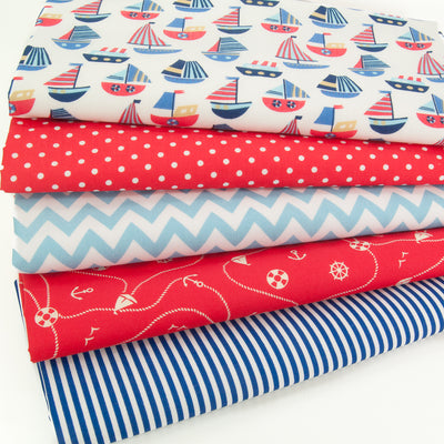 Five fat quarters of polycotton prints with red and blue stripey boats, red spots, blue stripes and a blue zig zag