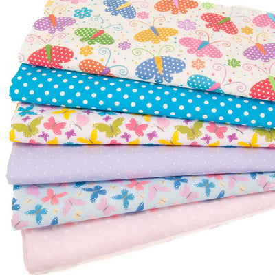A fat quarter bundle of 6 designs including 3 butterfly prints and 3 spotty fabrics