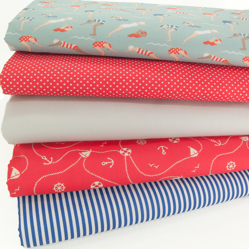 A fat quarter bundle of five polycotton fabrics with swimmers and a nautical theme
