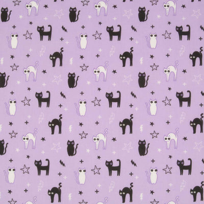 Black cats, stars and lightning bolts are printed on a lilac polycotton fabric