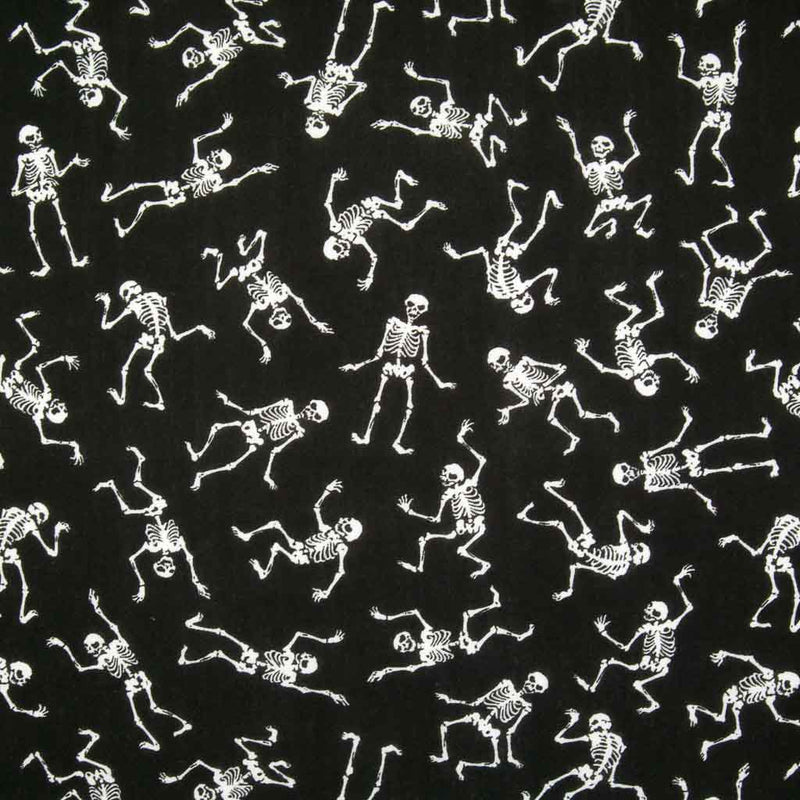 White mini skeletons in a scattered pattern dancing on black polycotton halloween fabric