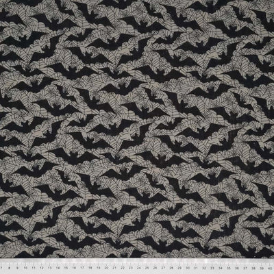 Flying black bats printed on a silvery grey polycotton with a cm ruler at the bottom