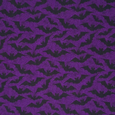 Flying black bats printed on a dark purple polycotton fabric