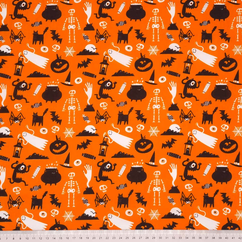 Halloween fabric printed with ghosts and ghouls on orange polycotton with a cm ruler at the bottom