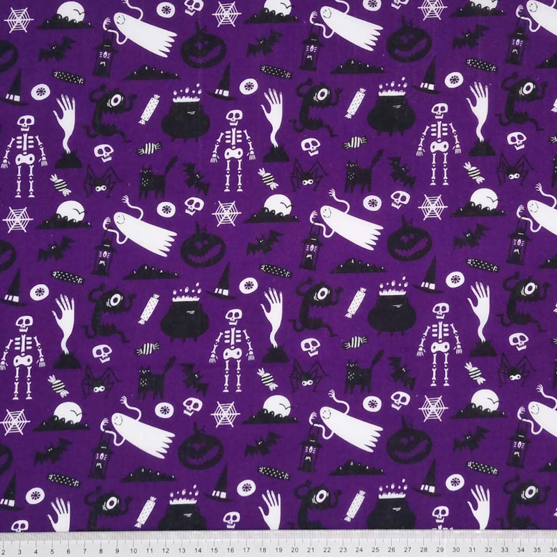 Halloween fabric printed with ghosts and ghouls on a purple polycotton with a cm ruler at the bottom