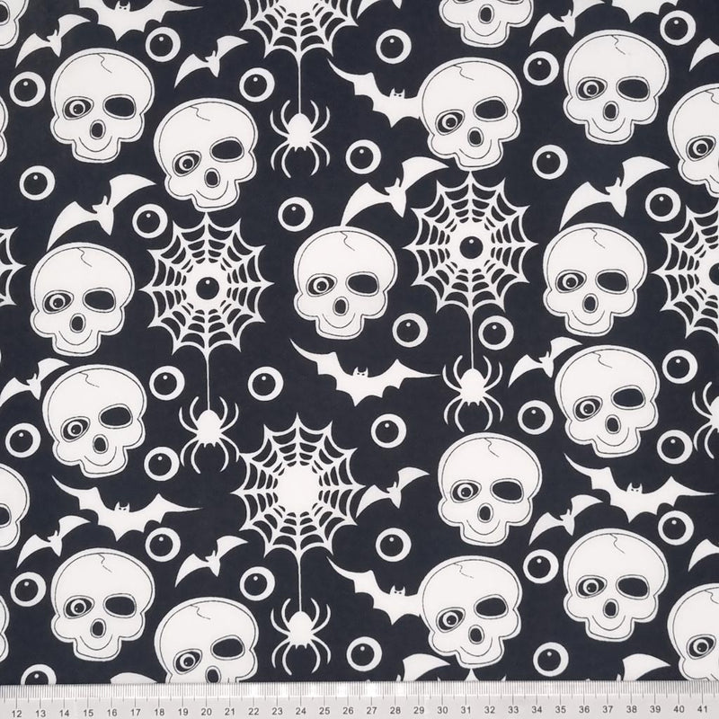 Skulls and bats printed on a black halloween polycotton fabric