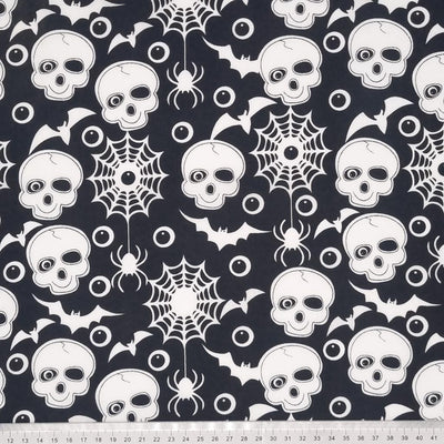 Skulls and bats printed on a black polycotton fabric