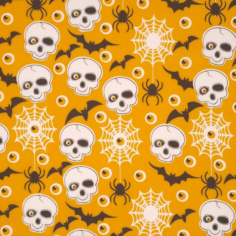 Skulls, eyeballs and bats printed on an orange halloween polycotton fabric