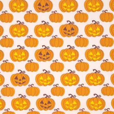 Glowing pumpkins are printed on a white polycotton fabric. 