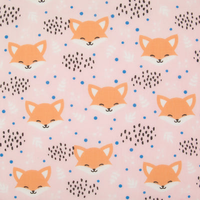 Smiling fox faces are printed on a baby pink polycotton fabric