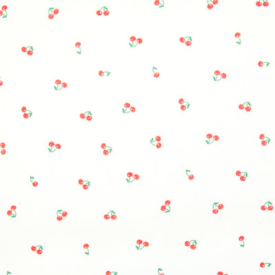 Ditsy red cherries are printed on a white polycotton fabric