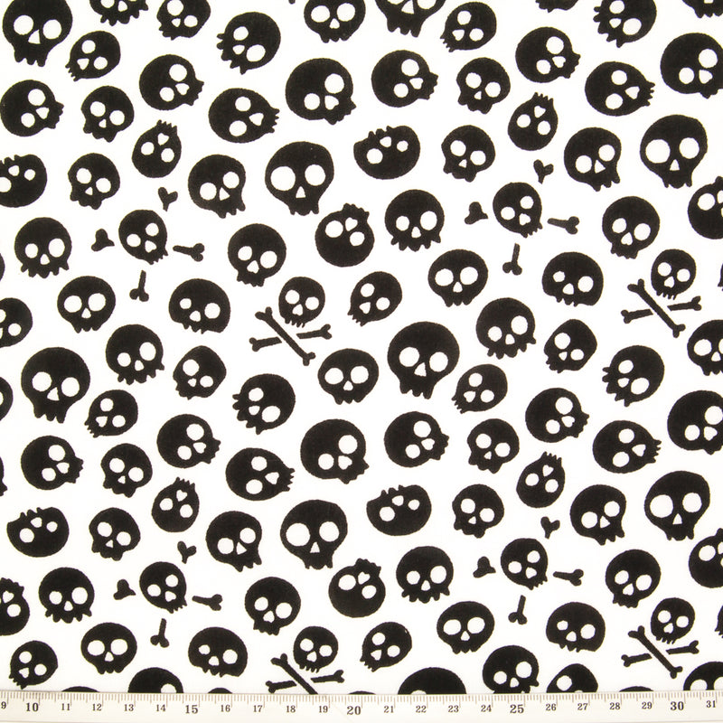 Black mini skulls printed on a white halloween polycotton fabric