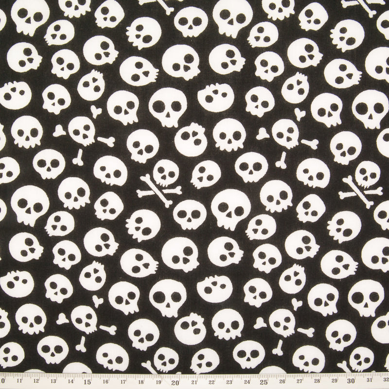 White mini skulls printed on a black halloween polycotton fabric