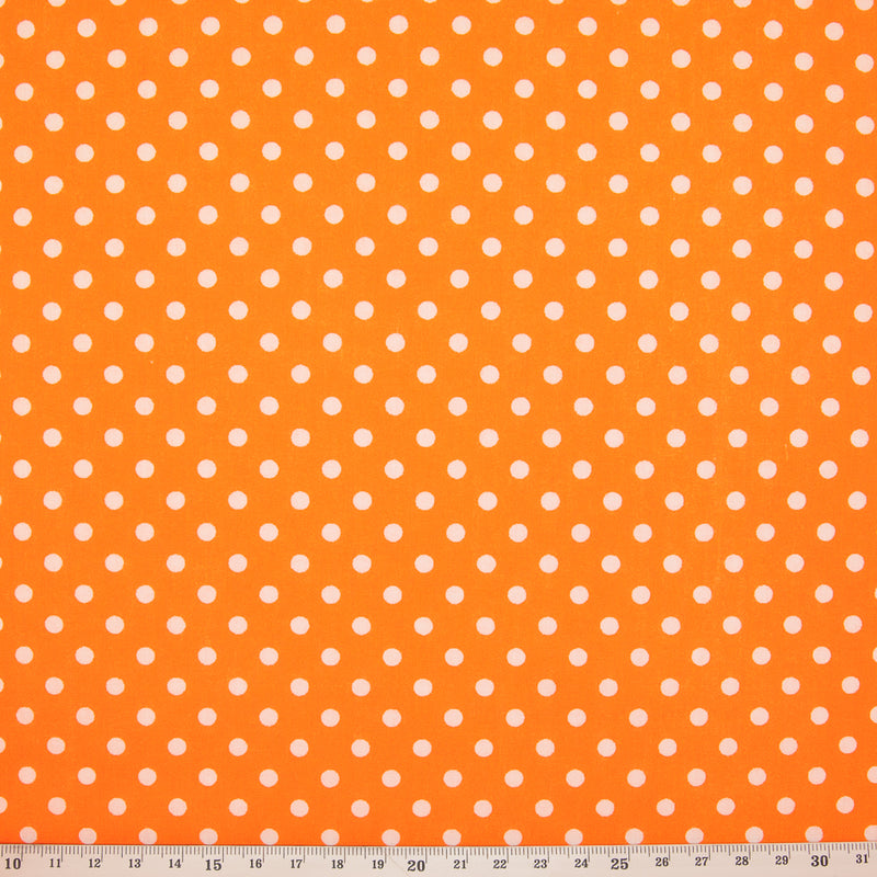 White spots printed on an orange polycotton fabric