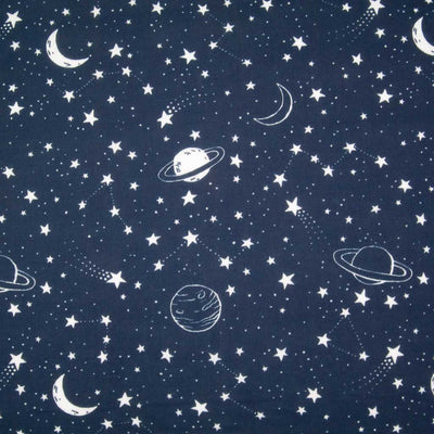 White stars, planets and moons are printed on a navy blue polycotton fabric
