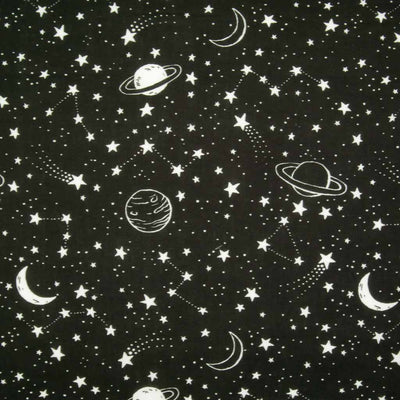 White stars, planets and moons are printed on a black polycotton fabric