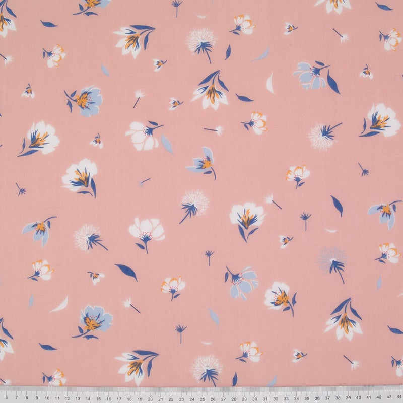 Pretty dandelions are printed on a pastel pink polycotton fabric with a cm ruler at the bottom