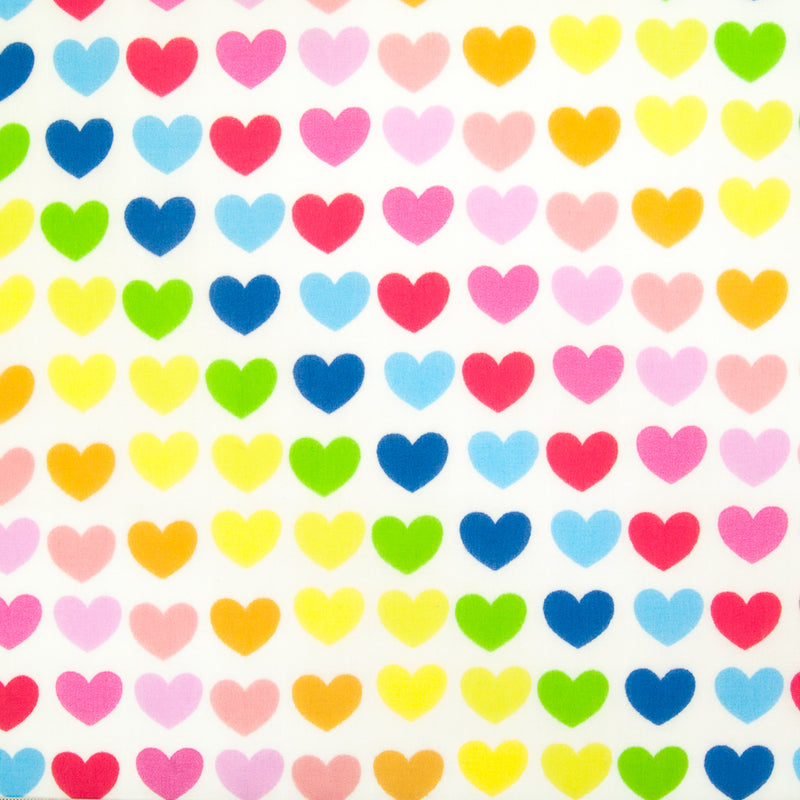 Lines of brightly coloured hearts are printed on a fat quarter of white polycotton fabric