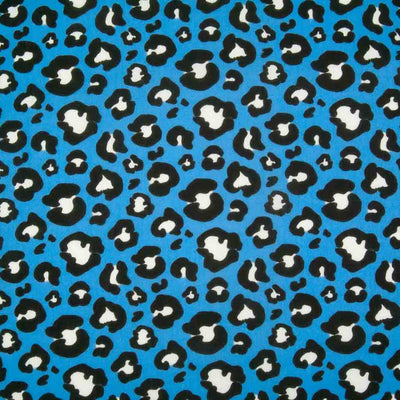 White and black leopard spots printed on a bright blue polycotton fabric
