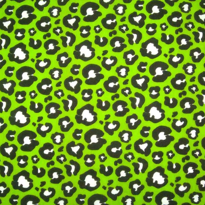 Striking white and black leopard spots printed on a green polycotton fabric