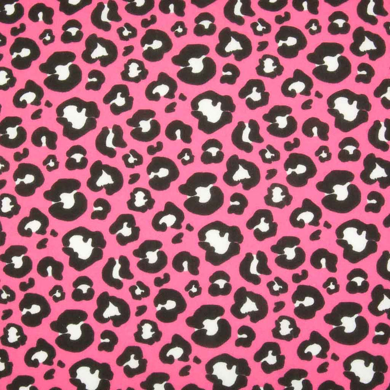 White and black leopard spots printed on a bright pink polycotton fabric