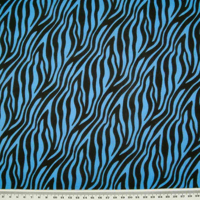 Zebra print polycotton fabric in blue and black with a ruler at the bottom for size perspective
