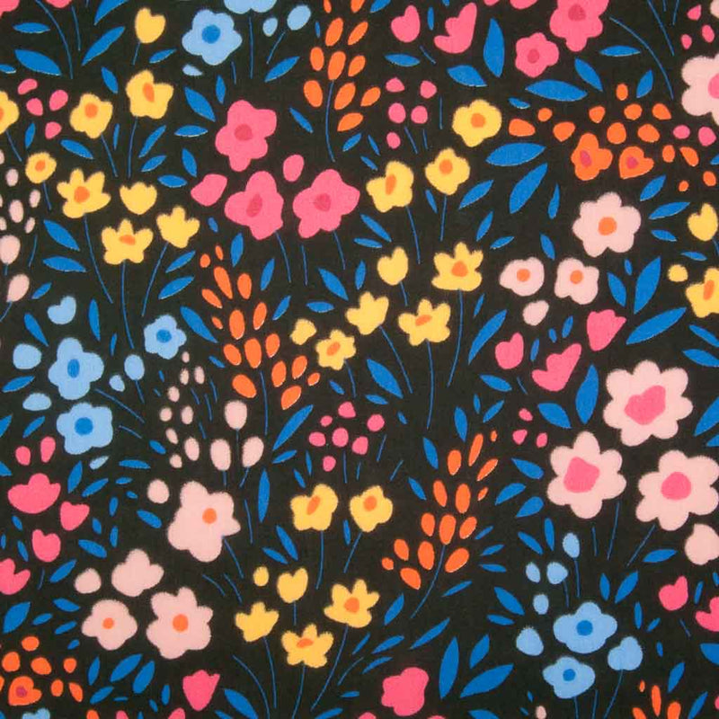 Primary coloured flowers printed on a black  polycotton fabric