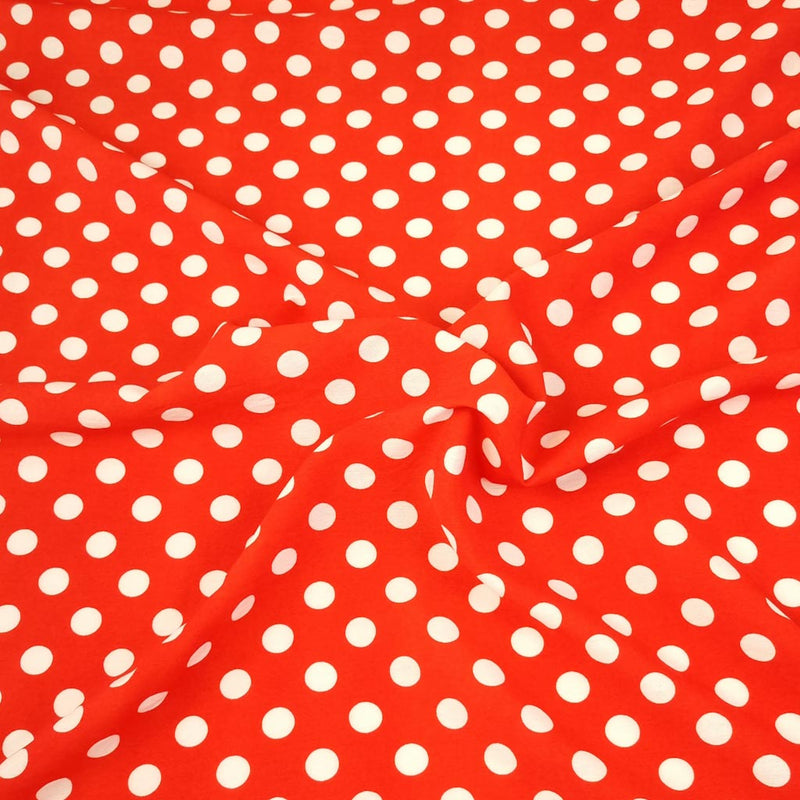 White polka dots on a red rayon fabric