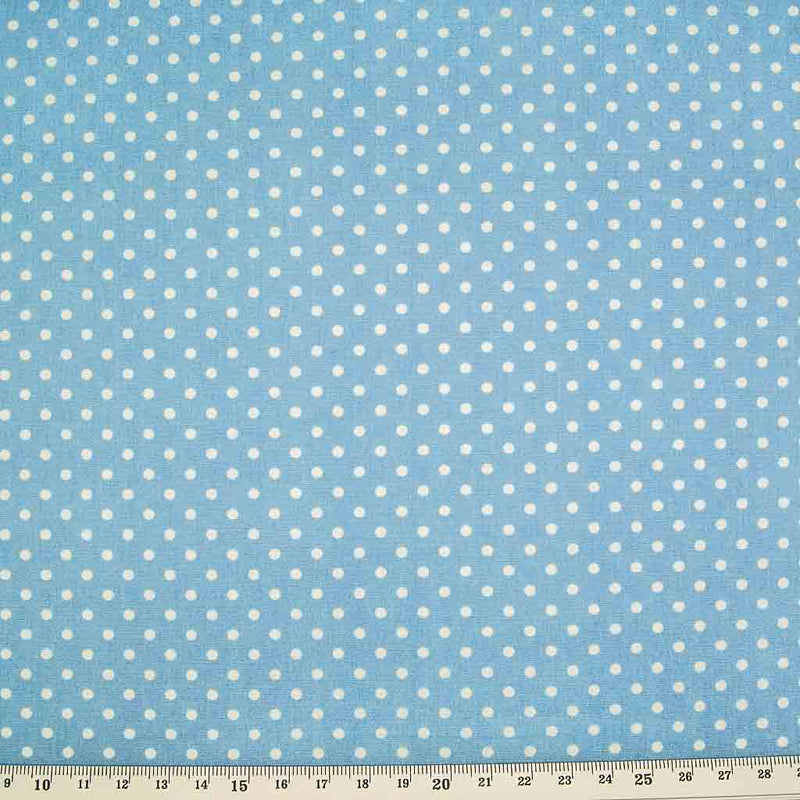 Small white spots are printed on a pale blue cotton poplin by Rose & Hubble with a cm ruler at the bottom