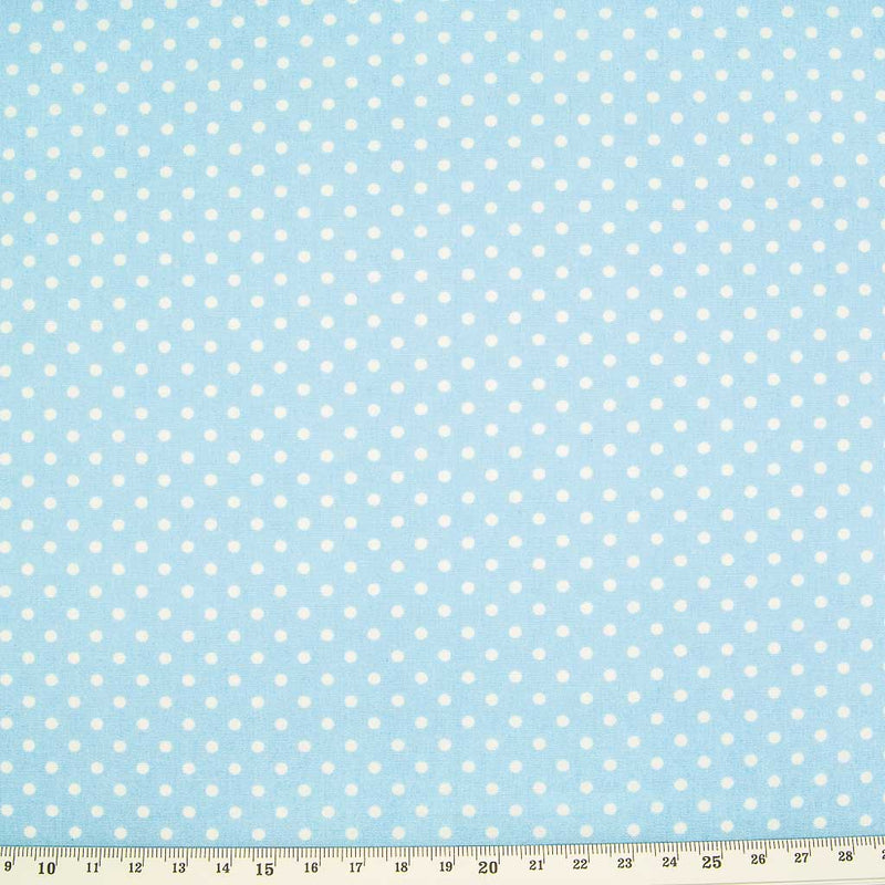 Small white spots are printed on a light powder blue cotton poplin by Rose & Hubble with a cm ruler at the bottom