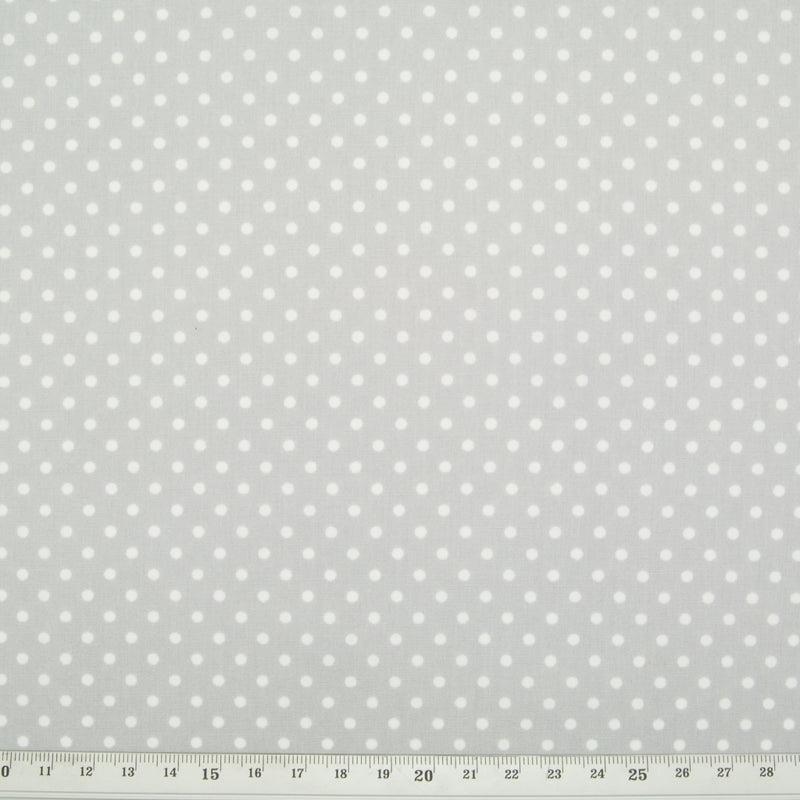 Small white spots printed on a silver cotton fabric with ruler for perspective
