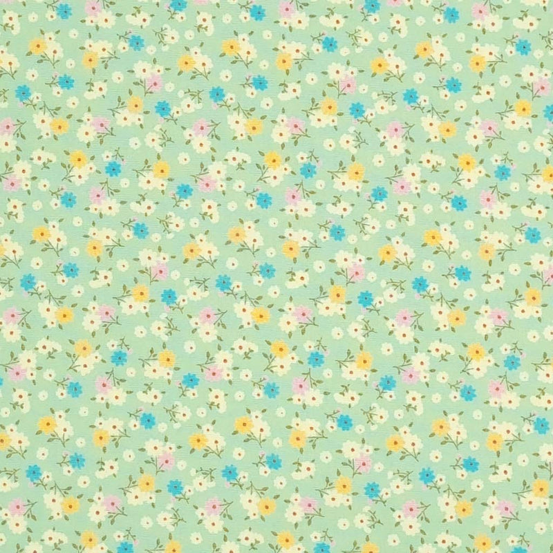 Tiny bunches of pink, blue and yellow flowers on a meadow green Rose and Hubble cotton poplin fabric