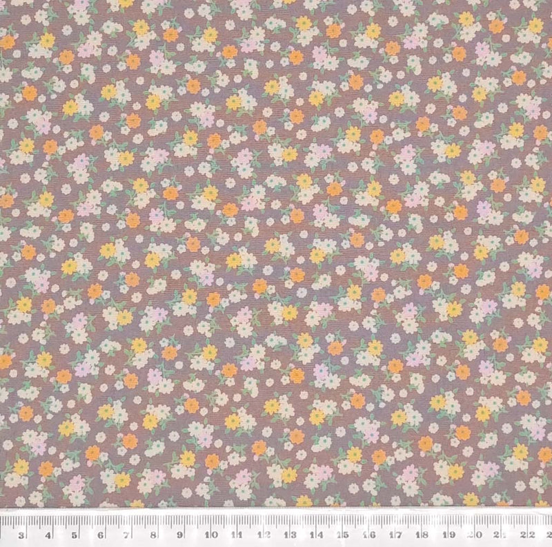 Tiny bunches of pink, orange and white flowers on a taupe Rose and Hubble cotton poplin fabric with a cm ruler