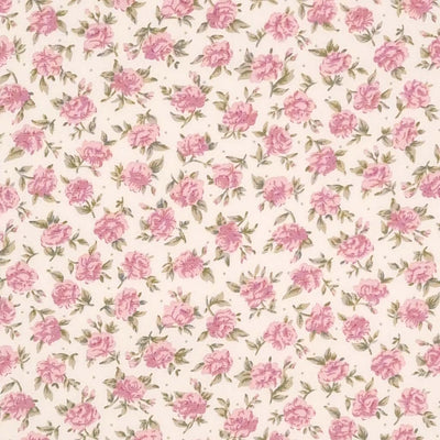 A dense pattern of pink roses printed on an ivory cotton poplin fabric by Rose & Hubble