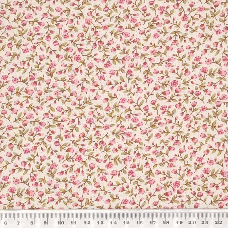 A ditsy pink floral pattern is printed on a cream Rose & Hubble cotton poplin fabric with a cm ruler