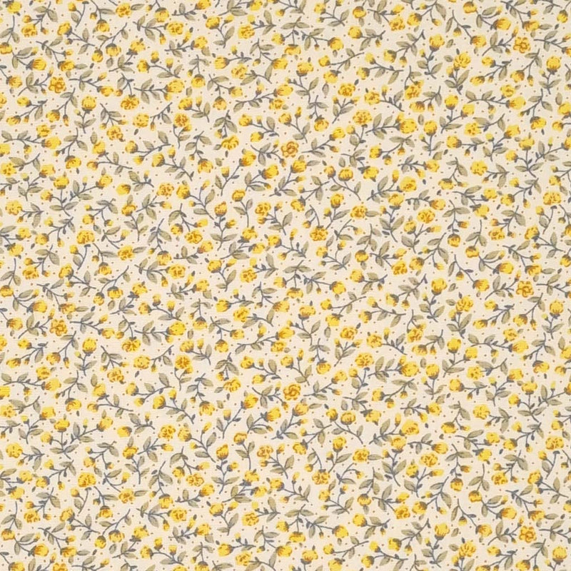 Tiny yellow flowers with green stems are printed on a cream Rose & Hubble cotton fabric